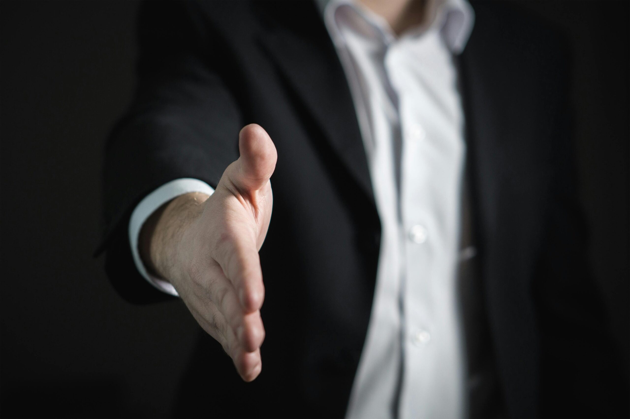 extending a handshake in face to face selling