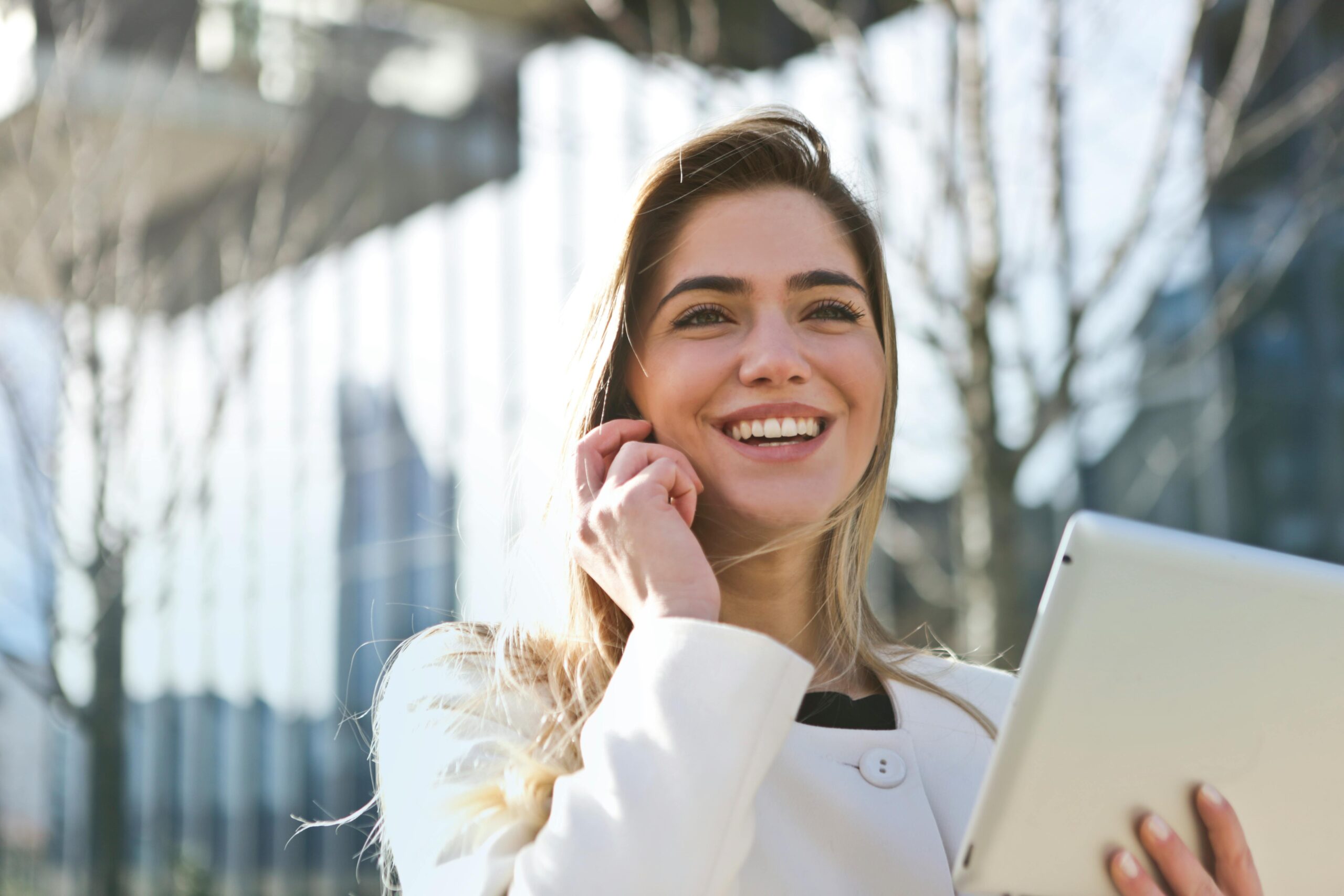 Woman holding a tablet.